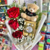 Three elegant roses, a charming teddy bear, and a box of fine