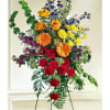 Share their grief with this distinctive display. The colorful arrangement includes orange