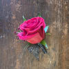Red Rose Boutonniere With Black Sparkle Ribbon, Red Rhinestones And Greenery.