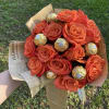 12 orange roses and chocolates wrapped.  Glass vase not included