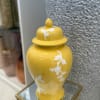 A vibrant decorative piece with a blend of yellow and white tones