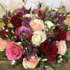 HEART SHAPE BOX WITH ONLY ROSES AND FILLERS .  THE ROSES