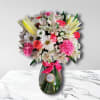&bull; Carnations
&bull; Daisies
&bull; Alstroemerias
&bull; Roses
&bull; Lilies
&bull; Glass vase