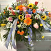 Mixed blue delphinium, gerbera daisies, grevellia, carnations, sunflowers and orlaya