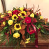 Yellow roses with burgundy mums, carnations, sunflowers, vykings, magnolia and grevellia foliages