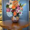A fresh mix of pinks and oranges that combine roses and seasonal