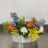 Colorful assortment of fresh flowers arranged in an envelope shaped keepsake vase.