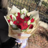The intensity of red roses blends with the delicacy of white tulips