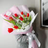 A stunning combination of vibrant red tulips and the soft, airy beauty