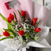 A stunning combination of vibrant red tulips and the soft, airy beauty