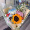 Products include sunflowers, China mums, spray roses in wrapping paper 