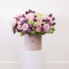 The arrangement includes the following flowers; peonies, lilacs, spray roses and hydrangea.