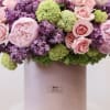 The arrangement includes the following flowers; peonies, lilacs, spray roses and hydrangea.
