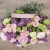 The arrangement includes the following flowers; peonies, lilacs, spray roses and hydrangea.