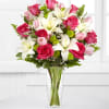 A mix of pinks and whites in a tall vase