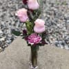 Roses and wax flower in a heart shaped desk size bud vase.