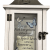 Wood with metal top lantern with an LED lighted candle. Ivy and