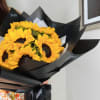 For sunflower lovers.  Vibrant sunflowers wrapped in black paper, creating a