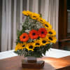 Beautiful arrangement of sunflowers in ceramic vase in ladder way style 