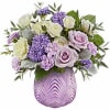 Whimsically enchanting, this lovely bouquet of lavender and light yellow blooms is