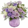Whimsically enchanting, this lovely bouquet of lavender and light yellow blooms is