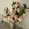 Softly colored blooms in pink and cream. Made with ranunculus and sweetpeas