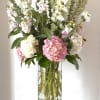 Tall arrangement with a lot of textures. 
Flowers include hydrangeas, delphinium, stock