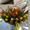 Yellow and orange tulips, beautifully arranged with bright green stems and leaves