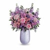 What a treat! Overflowing with pink roses and lavender blooms, this stunning
