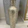 
A dazzling glass vase with a mosaic design, reflecting light beautifully to