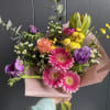 Seasonal, colorful flowers and foliage wrapped in floral paper. No vase included.

Year
