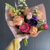 Seasonal, colorful flowers and foliage wrapped in floral paper. No vase included.

Year