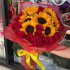 Sunflowers with a mix of red roses in red paper. 20 Roses