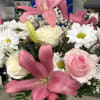 Get a pink and white themed arrangement to welcome that new little