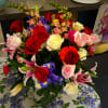Red, white and pink roses with lilies and assorted filler flowers 