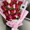 A beautiful arrangement of roses displayed in a column, wrapped in delicate