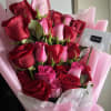 A beautiful arrangement of roses displayed in a column, wrapped in delicate