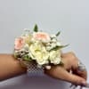 Elizabet corsage is made with white spray roses and peach spray roses