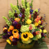 This green tub is filled with all of our favorite bright flowers