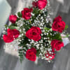 Dozen Roses with Babies Breath arranged in a Clear Vase