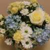A summer arrangement with pale yellows, blues and whites.  All in