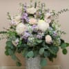 Imagine a galvanized fleur-de-lis container cradling soft, beautiful blooms in shades of