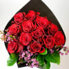 Our dozen red rose hand-tied bouquet is accented with wax flower and