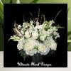 A graceful medley of white roses, hydrangeas, snapdragons, and delicate accents, designed