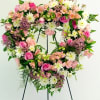 A beautiful heart shape funeral standing spray with a  combination of