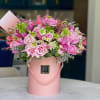 A delightful arrangement of soft pink roses, delicate blooms, and fresh greenery