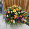 A stunning and lively celebration of life, this Vibrant Garden Casket Spray