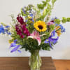 This gardeny flower arrangement features a variety of blooms, colors and textures