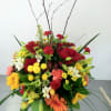 Vase of seasonal flowers accented with branches