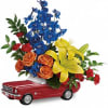 This colorful arrangement includes orange spray roses, yellow asiatic lilies, red carnations